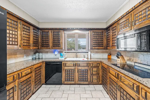 a kitchen with a sink stove and cabinets