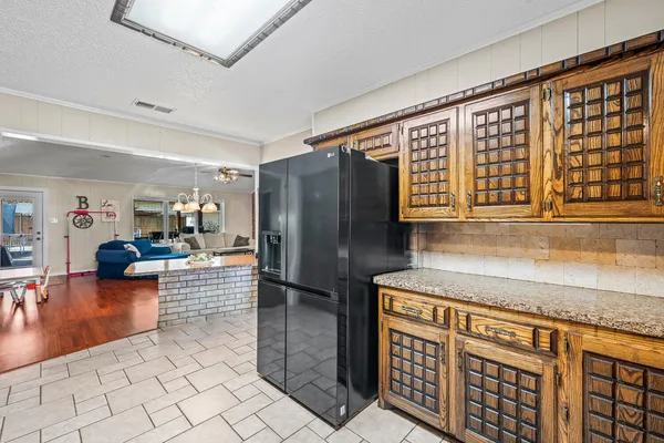 a kitchen with stainless steel appliances granite countertop a refrigerator and a sink
