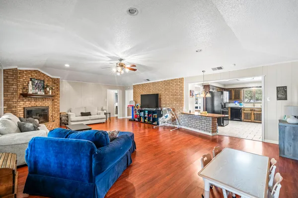 a living room with furniture and wooden floor