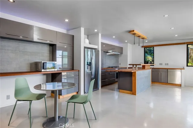 a view of a tables and chairs under an umbrella