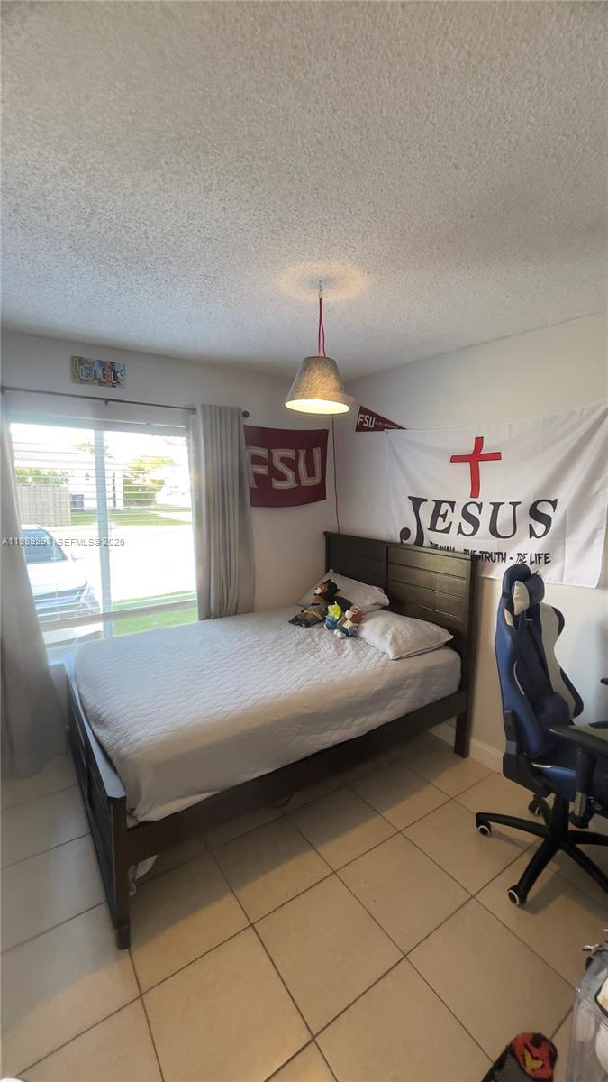 14252 Southwest 175th Terrace Miami, FL 33177 - Photo 17 of 39 a bedroom with a bed and a desk