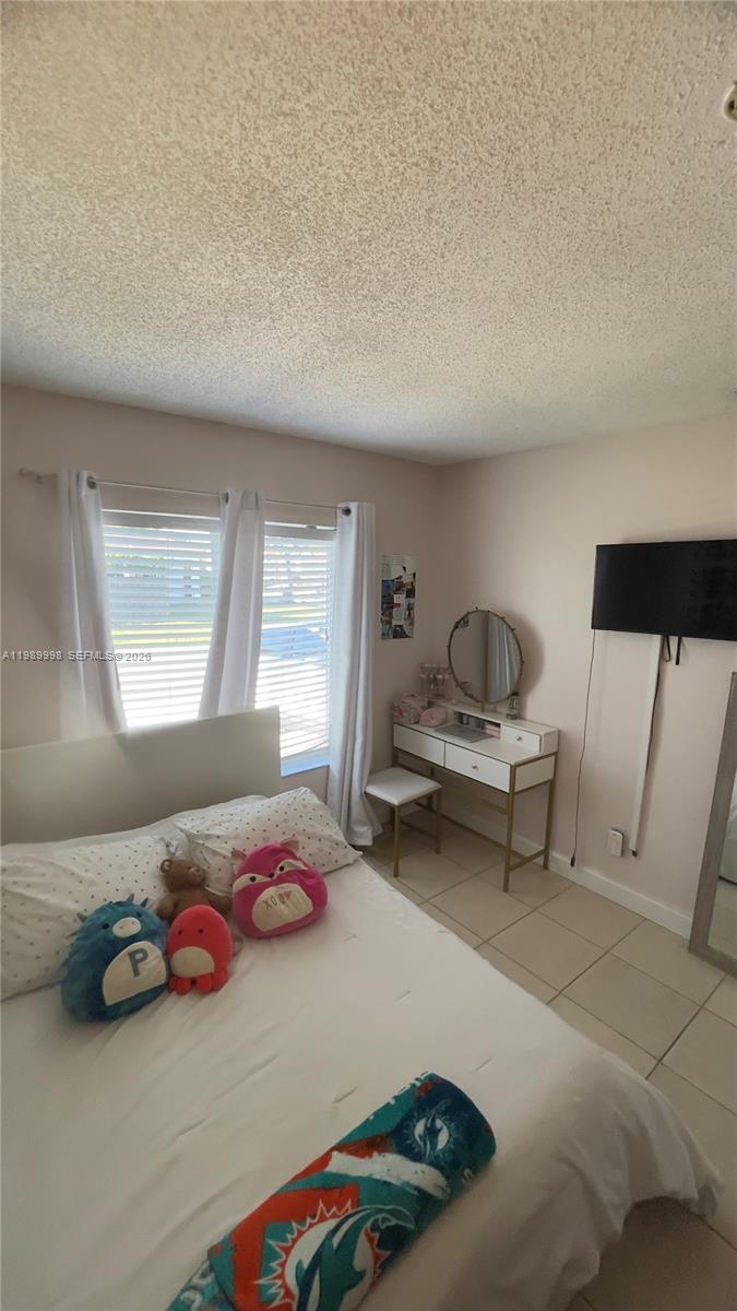 14252 Southwest 175th Terrace Miami, FL 33177 - Photo 23 of 39 a bedroom with furniture and a window