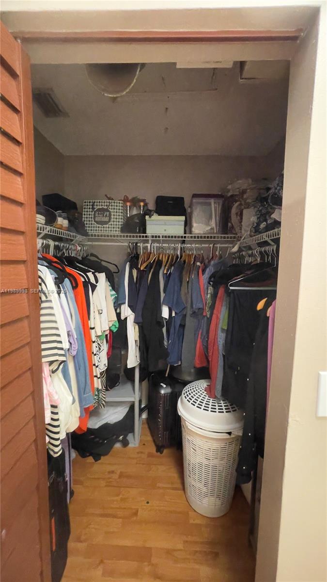 14252 Southwest 175th Terrace Miami, FL 33177 - Photo 31 of 39 a view of walk in closet with clothes and shoes