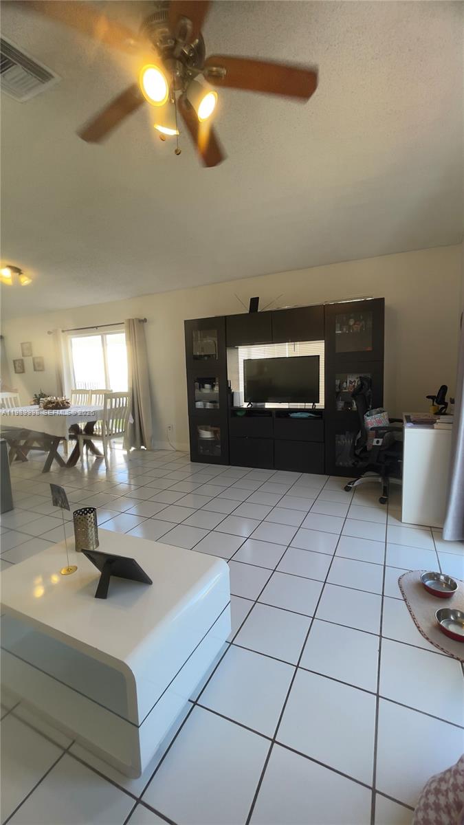 14252 Southwest 175th Terrace Miami, FL 33177 - Photo 37 of 39 a living room with furniture and a flat screen tv