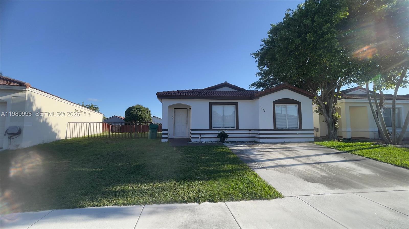 14252 Southwest 175th Terrace Miami, FL 33177 - Photo 6 of 39 a front view of a house with a garden