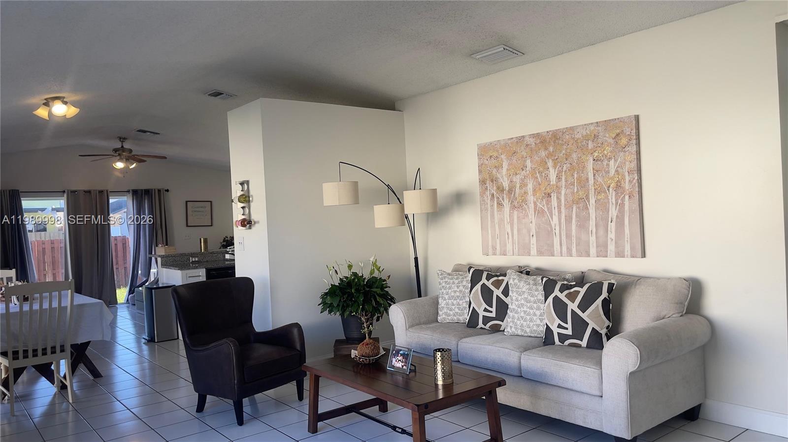 14252 Southwest 175th Terrace Miami, FL 33177 - Photo 7 of 39 a living room with furniture and a potted plant