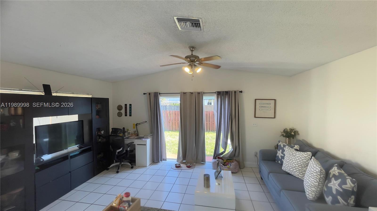 14252 Southwest 175th Terrace Miami, FL 33177 - Photo 8 of 39 a living room with furniture and a fireplace