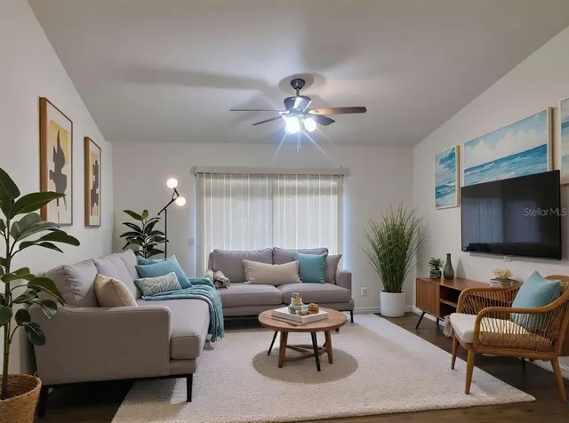a living room with furniture potted plant and a flat screen tv