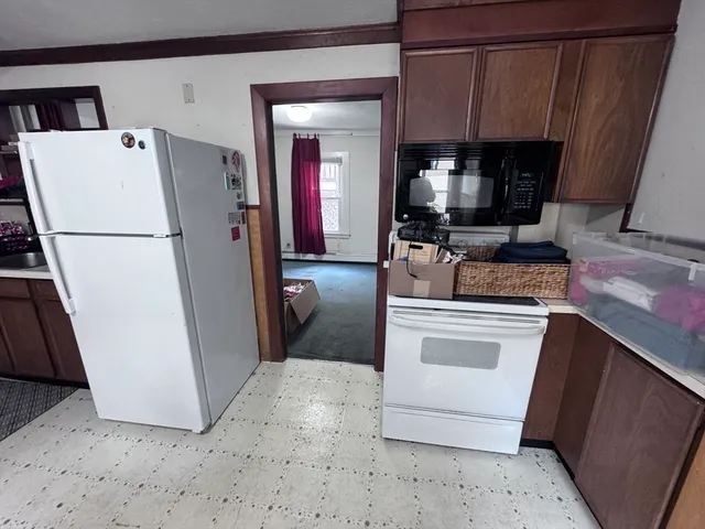 a kitchen with granite countertop a sink a stove and cabinets