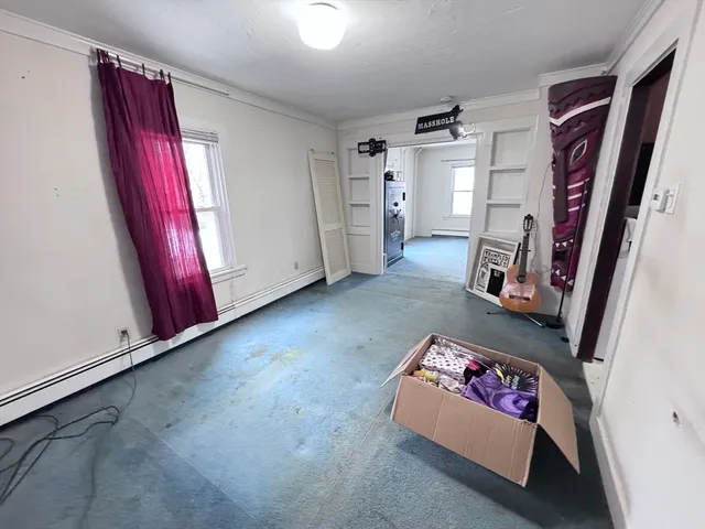 a living room with a chair and a window