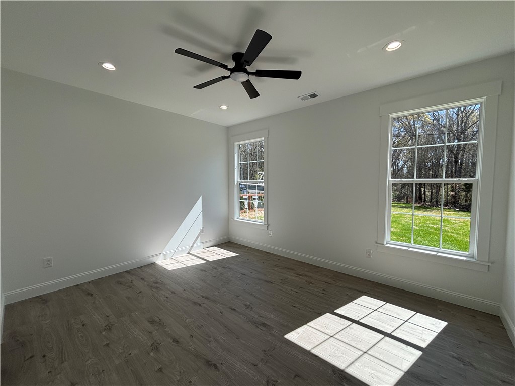 26 B Fisher Jenkins Road Anderson, SC 29625 - Photo 11 of 24 Bright and airy room with large windows offers serene views and comfortable living space.