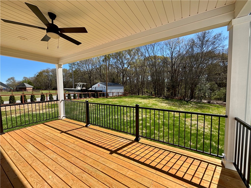 26 B Fisher Jenkins Road Anderson, SC 29625 - Photo 19 of 24 This spacious covered deck offers serene views of the expansive yard.
