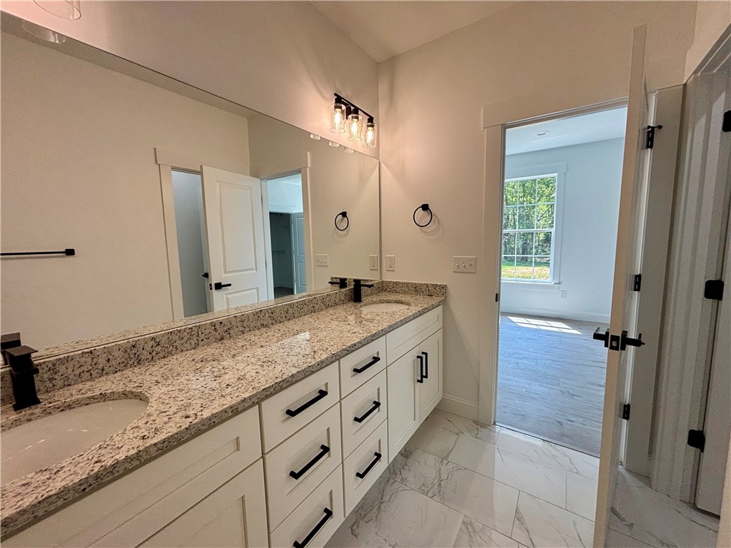 26 B Fisher Jenkins Road Anderson, SC 29625 - Photo 22 of 24 This primary bathroom features a double vanity and a spacious mirror.