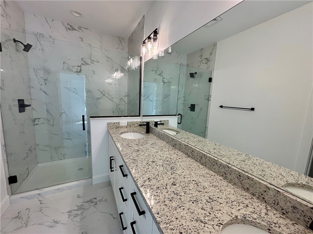 26 B Fisher Jenkins Road Anderson, SC 29625 - Photo 24 of 24 This bathroom features a double vanity and a spacious walk-in shower.