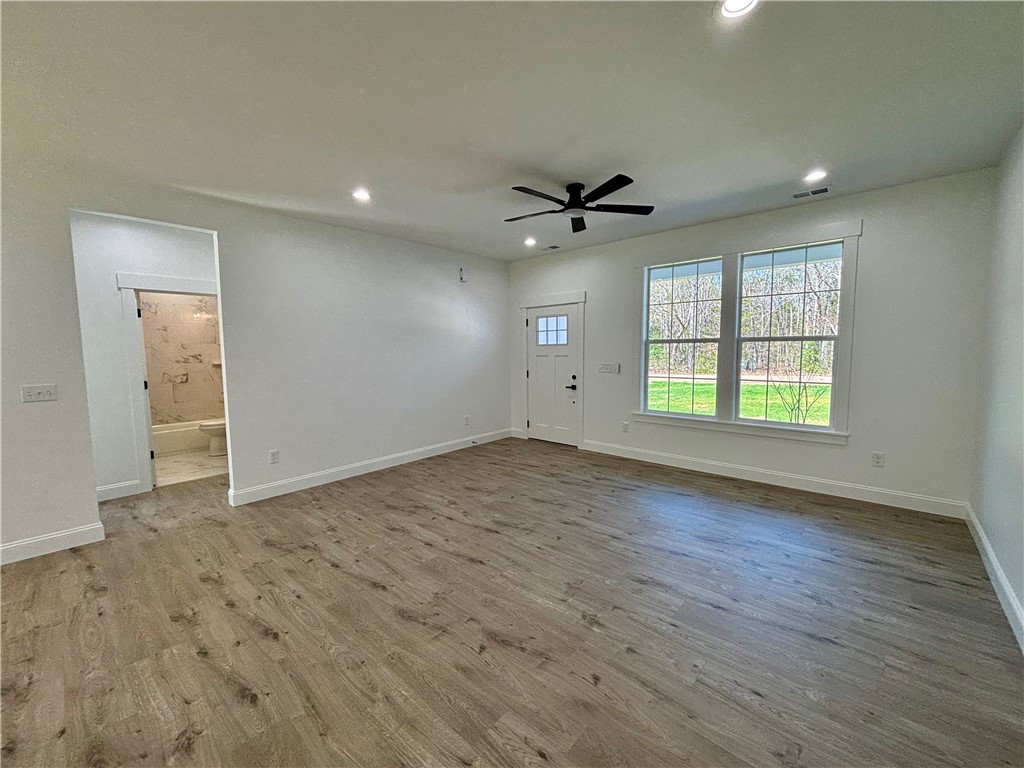 26 B Fisher Jenkins Road Anderson, SC 29625 - Photo 3 of 24 Bright and airy living space featuring expansive windows and durable flooring.