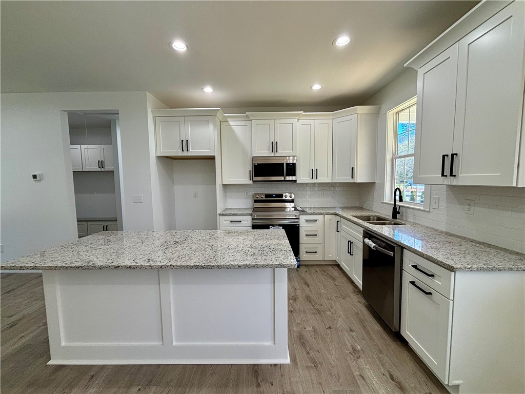 26 B Fisher Jenkins Road Anderson, SC 29625 - Photo 5 of 24 This bright kitchen features ample counter space and modern appliances, perfect for everyday living.