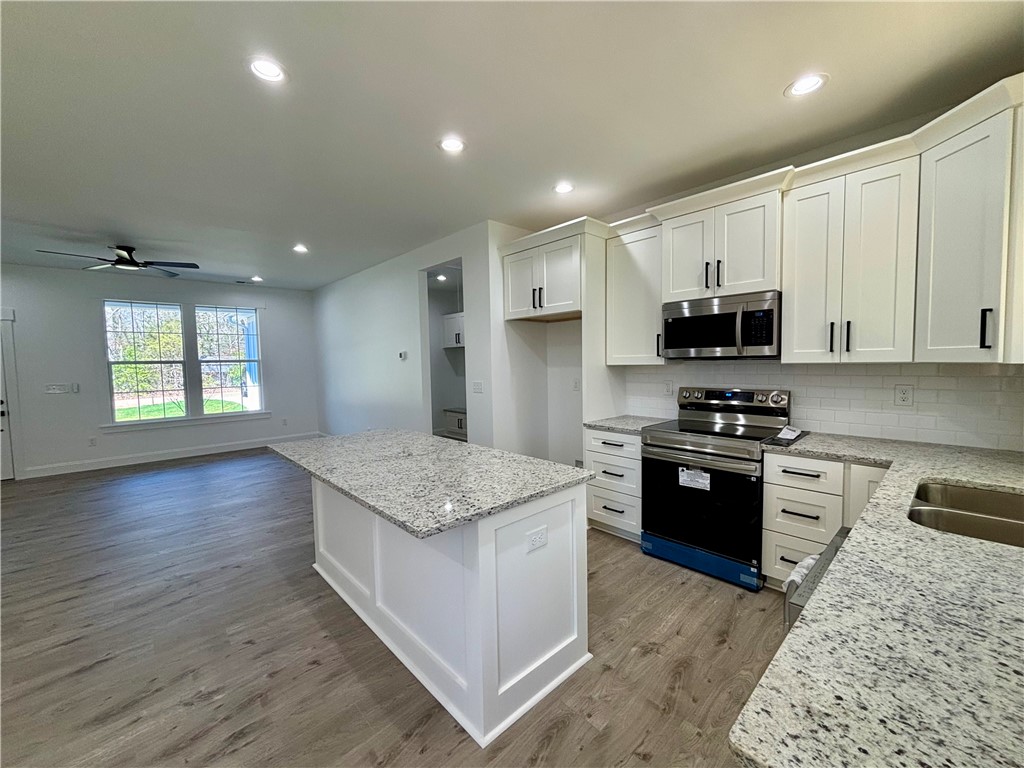 26 B Fisher Jenkins Road Anderson, SC 29625 - Photo 7 of 24 This kitchen and living area feature a spacious layout, perfect for daily living and entertaining.
