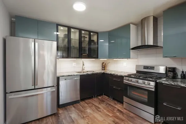 a kitchen with granite countertop stainless steel appliances and wooden cabinets