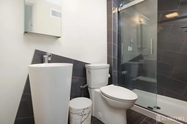 a white toilet sitting next to a bathroom sink