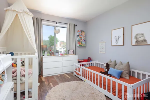 a living room with furniture and a baby crib