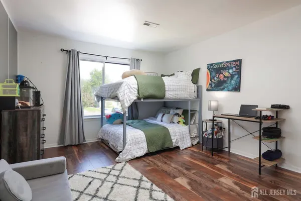 a bedroom with furniture and a window