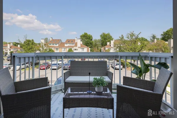 a view of a chairs and table in the balcony