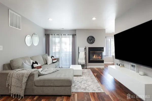a living room with furniture flat screen tv and a fireplace