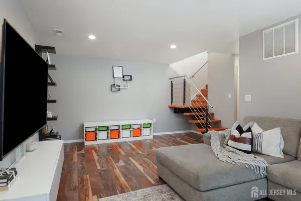 a bedroom with furniture and a flat screen tv