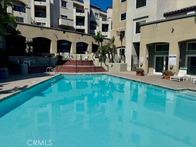 a swimming pool view with a outdoor seating space
