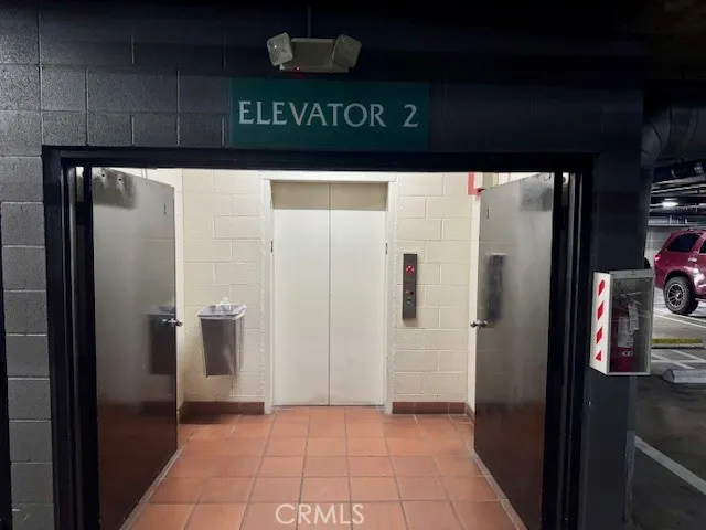 two windows and a yard in the back