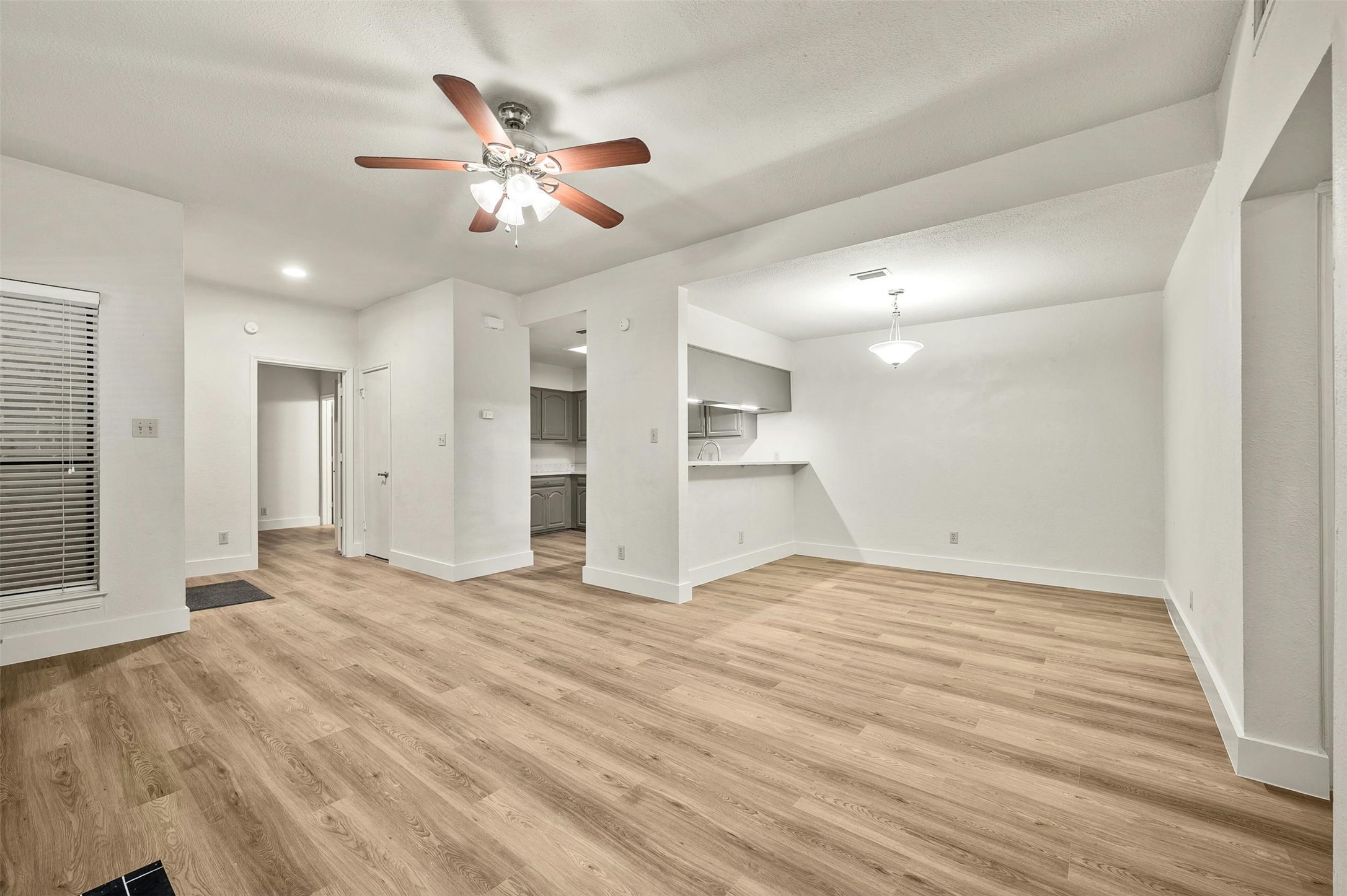 1910 Robbins Place, Unit 105 Austin, TX 78705 - Photo 10 of 30 Living room view toward dining and kitchen