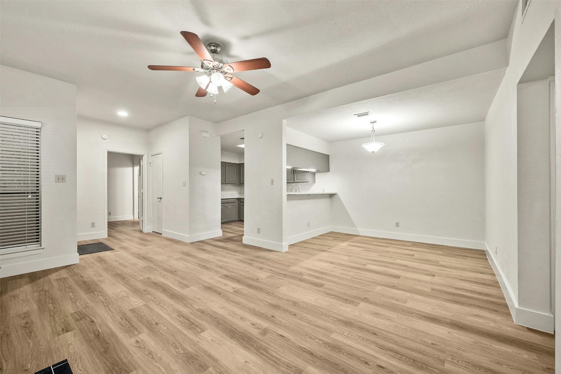 1910 Robbins Place, Unit 105 Austin, TX 78705 - Photo 10 of 30 Living room view toward dining and kitchen