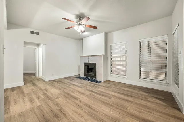 a view of an empty room with a ceiling fan