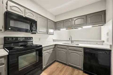 a kitchen with stainless steel appliances a stove sink and microwave