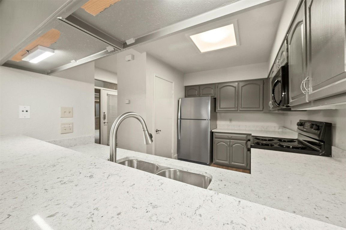 1910 Robbins Place, Unit 105 Austin, TX 78705 - Photo 16 of 30 Kitchen with granite countertops and ample prep space