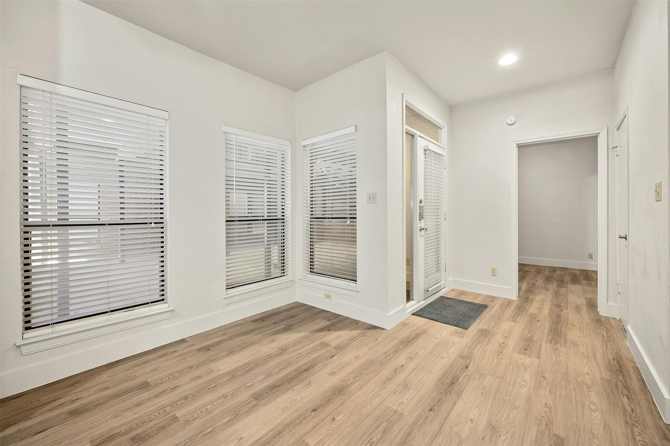1910 Robbins Place, Unit 105 Austin, TX 78705 - Photo 9 of 30 2nd Angle, Entry foyer with plank flooring and high ceilings