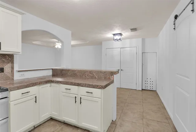 a view of a house with backyard and porch