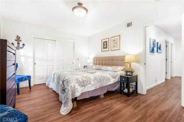 a spacious bedroom with a bed and a table in it