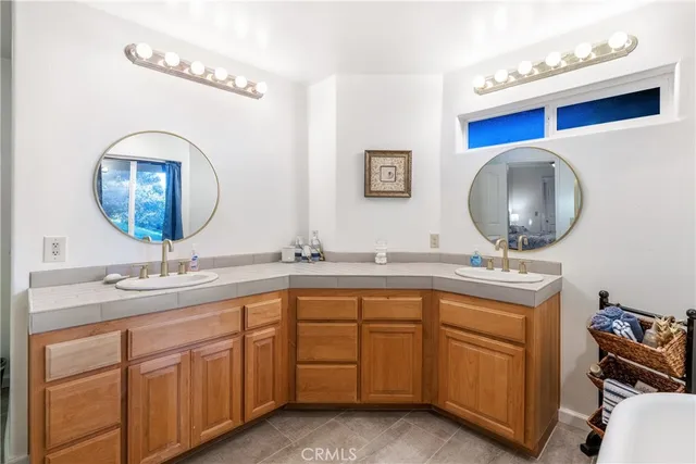 a bathroom with a double vanity sink and a mirror