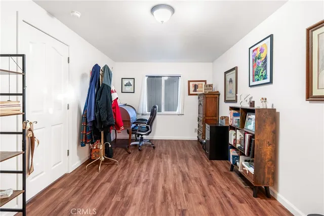 a view of a room with furniture and wooden floor