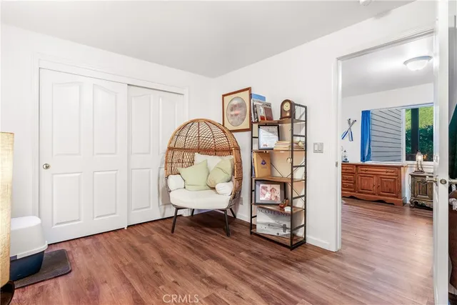a view of living room filled with furniture and wooden floor