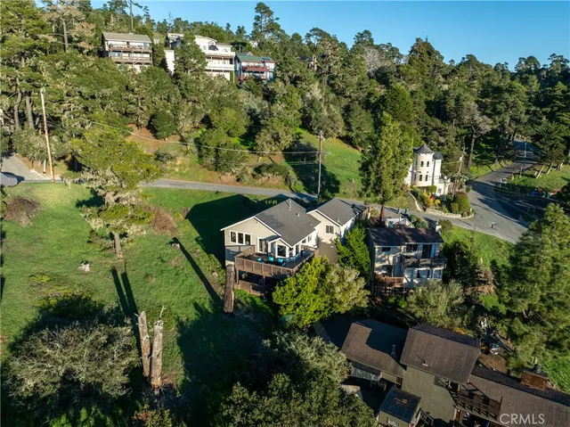 a view of a balcony with wooden floor and outdoor seating