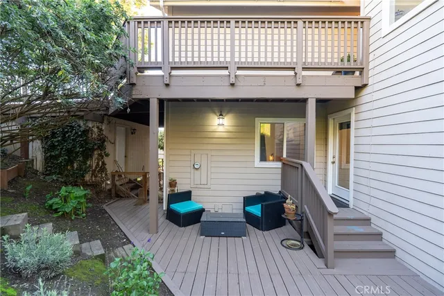 a view of a house with a small yard and potted plants