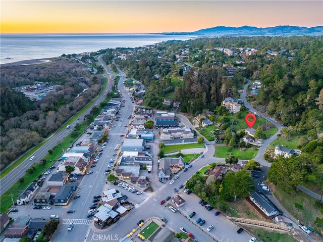 a view of a house with wooden fence and trees