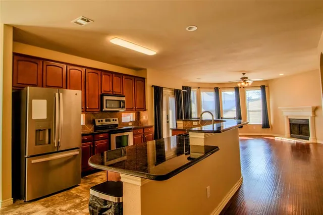 a living room with furniture fireplace and a large window