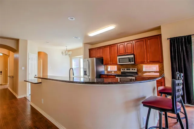 a view of a livingroom with wooden floor and a fireplace