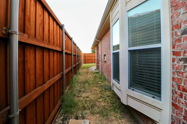 a view of a door and brick walls