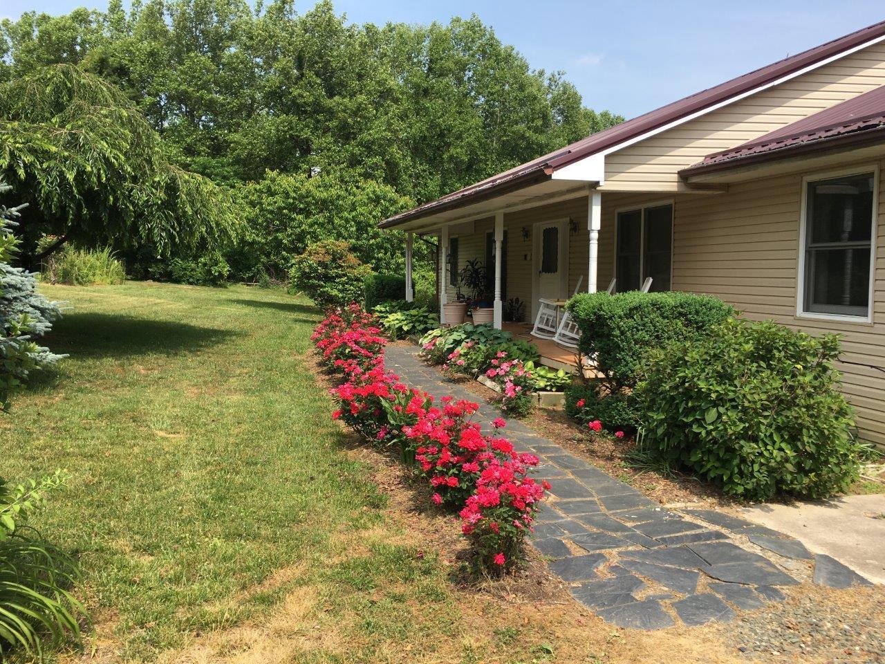 289 Radford Road Southeast Floyd, VA 24091 - Photo 2 of 32 a view of a house with a yard and garden