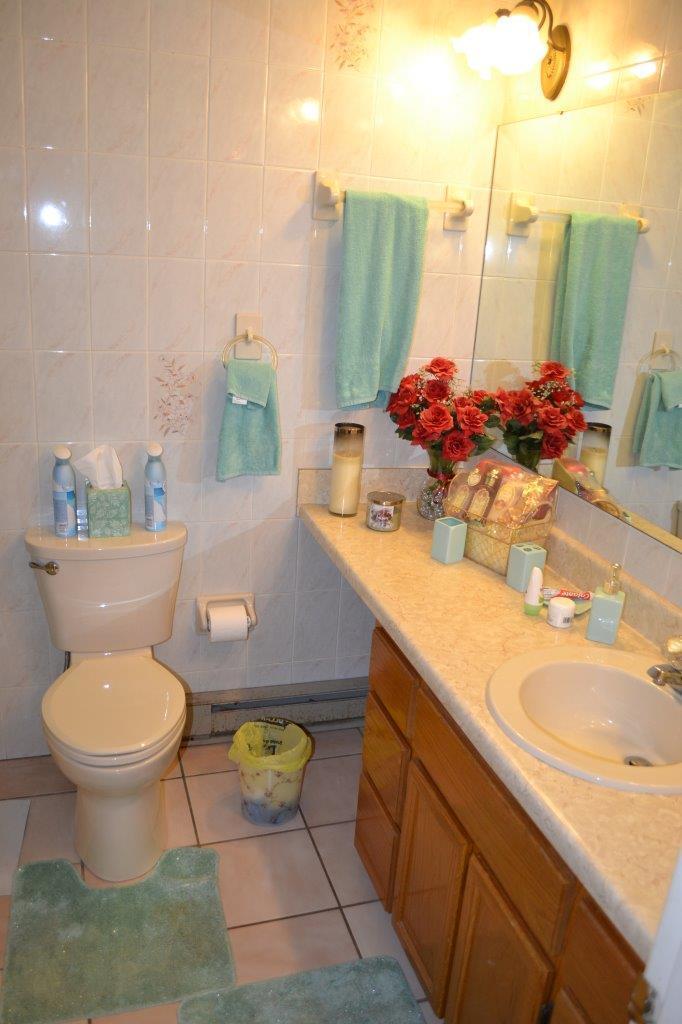 289 Radford Road Southeast Floyd, VA 24091 - Photo 14 of 32 a bathroom with a granite countertop toilet sink and mirror