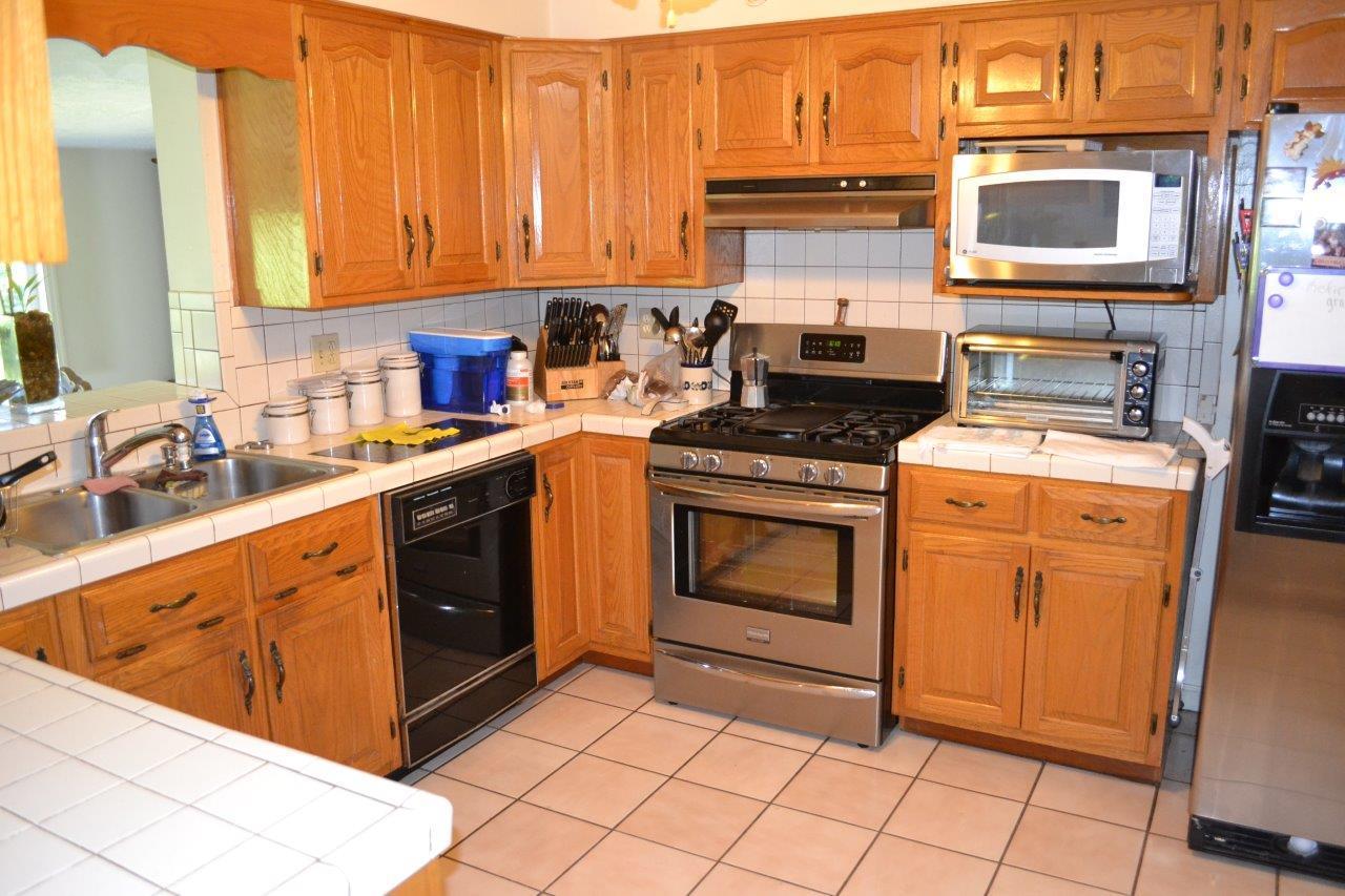 289 Radford Road Southeast Floyd, VA 24091 - Photo 18 of 32 a kitchen with stainless steel appliances granite countertop a stove a sink and a microwave